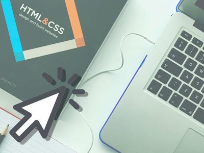 laptop next to book "HTML and CSS"